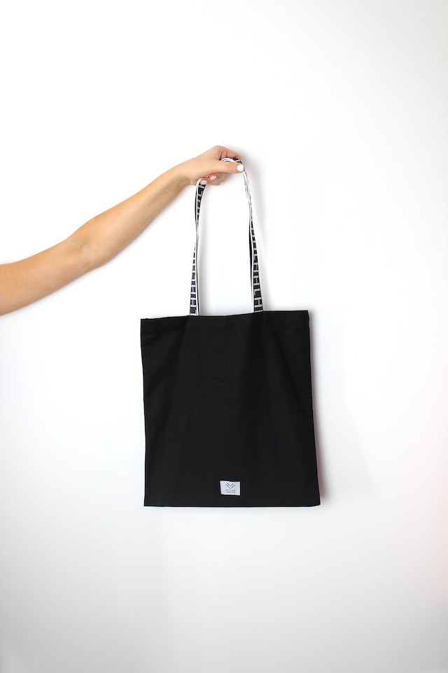 black bag holding by a model's hand 